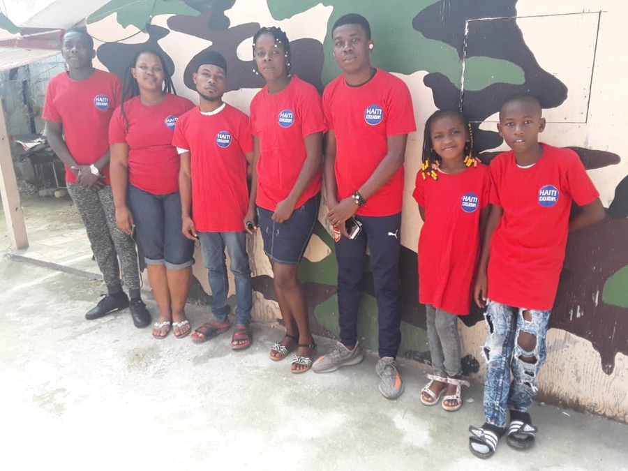 A group of older scholarship students in red shirts